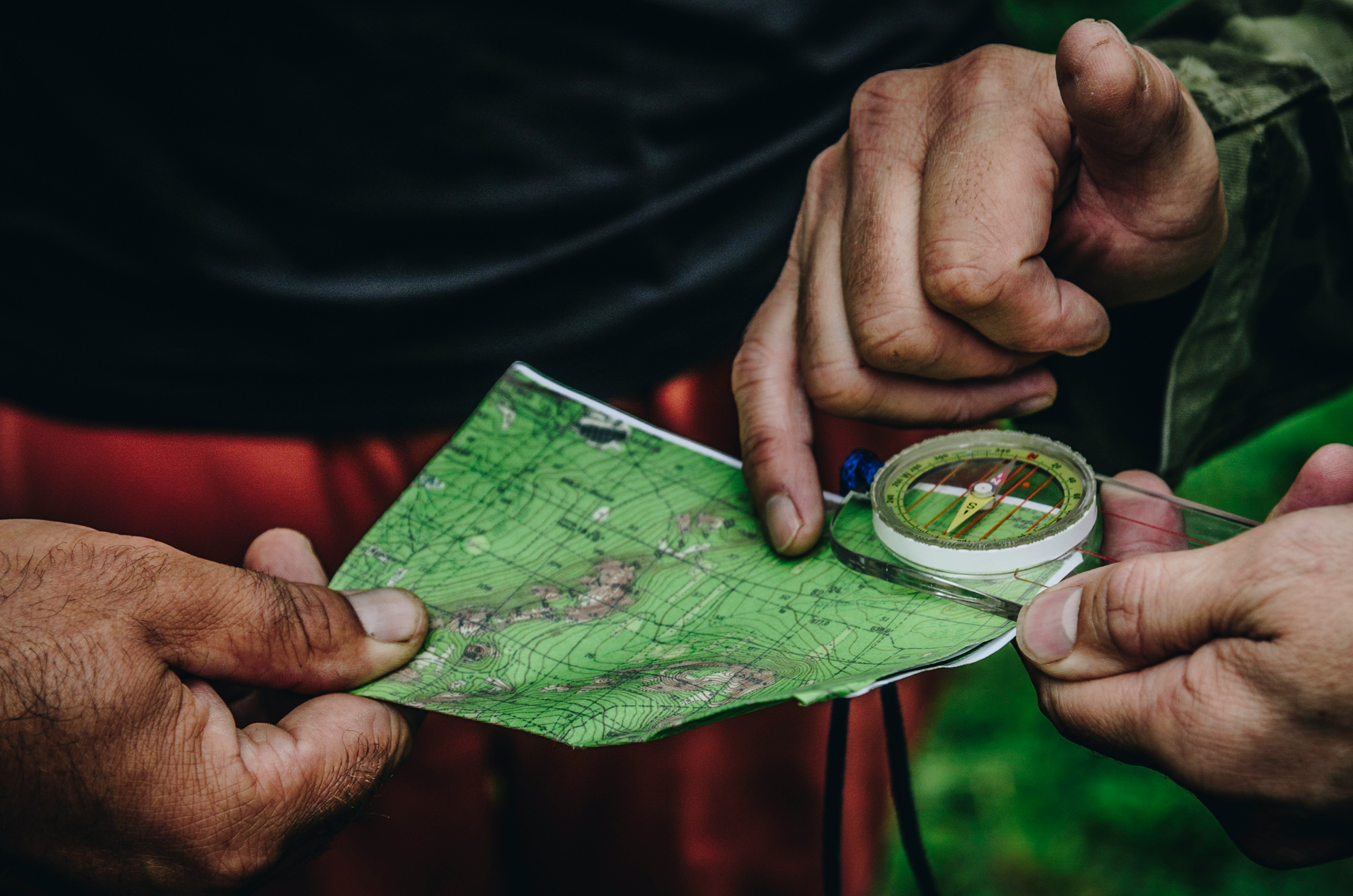 Two person holding map and clear compass photo